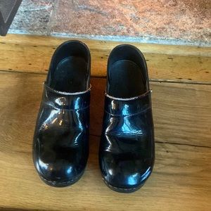 Dansko black patten leather clogs
